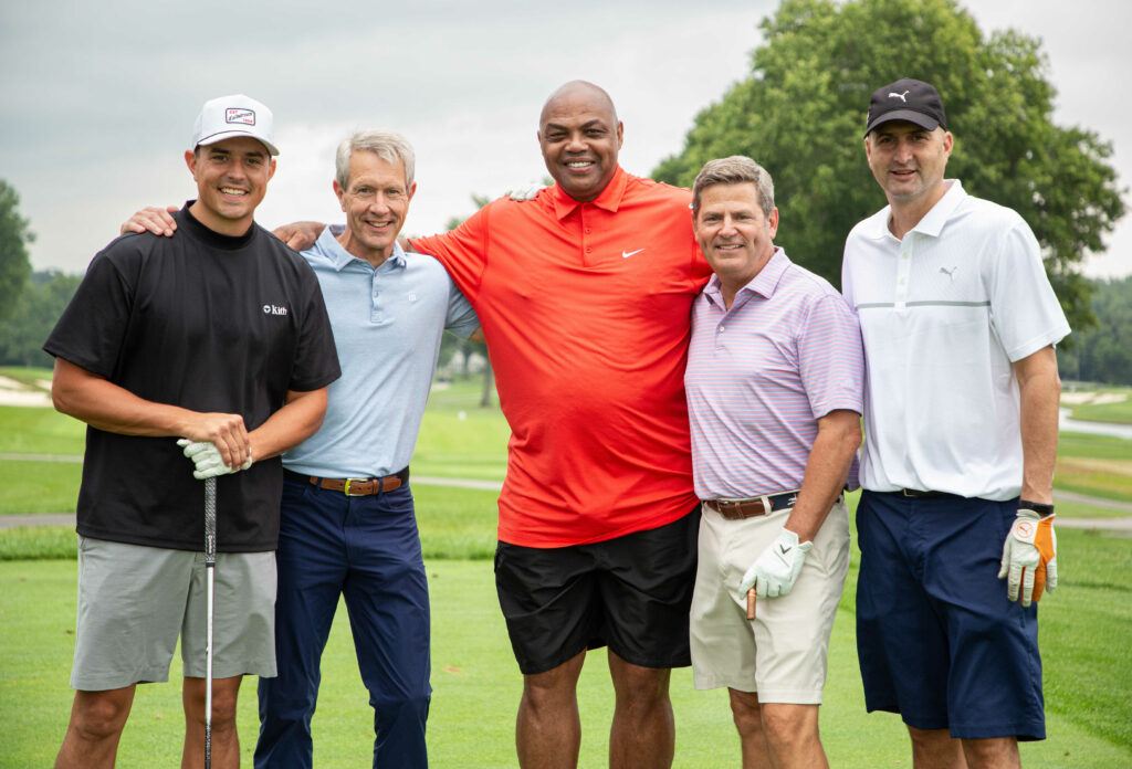Group photo of Charles Barkley with his golf teammates on a golf course at the Joel Cornette Foundation 2022 Annual Golf Outing